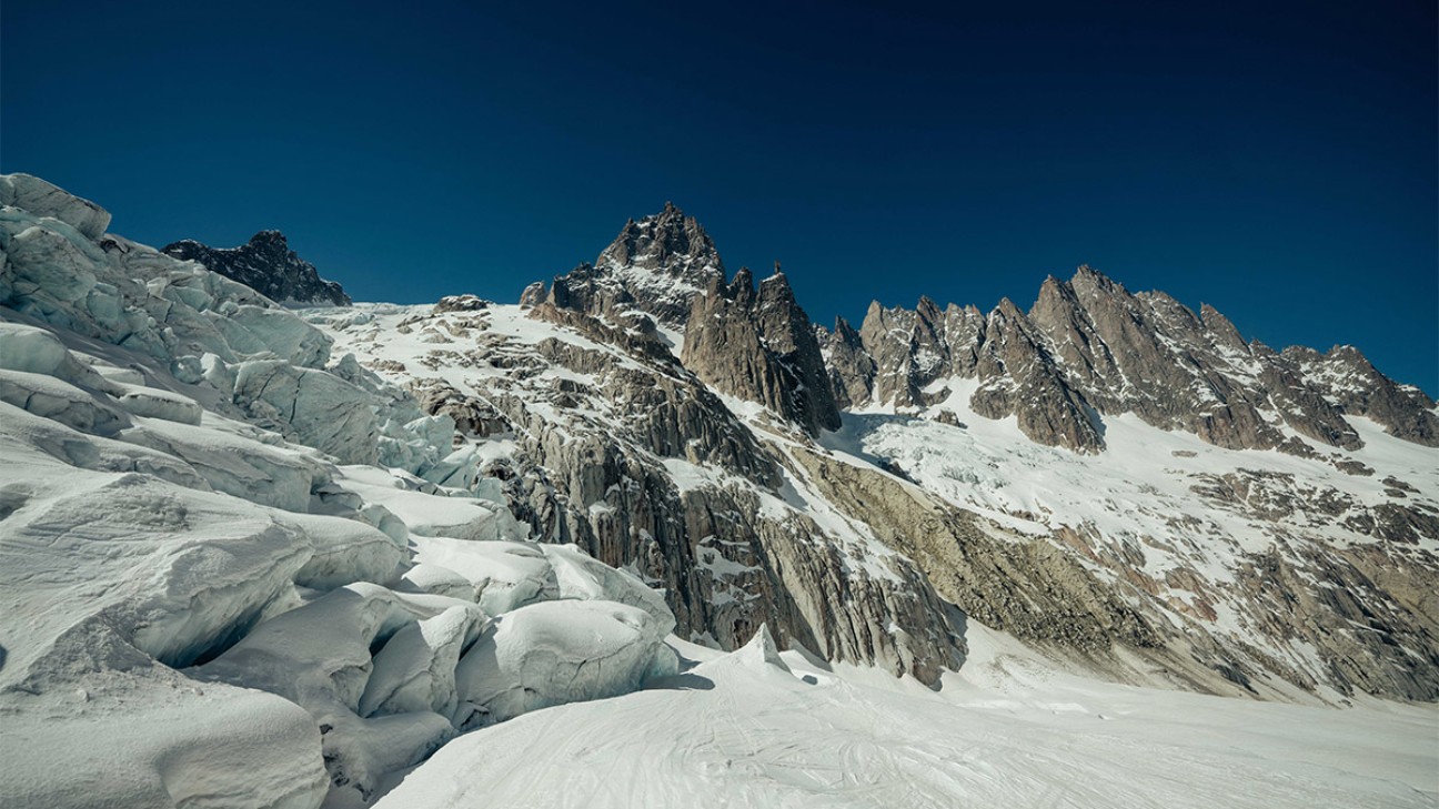 Giving Tuesday featured image for KUHL - a snow covered mountain with dark-blue sky