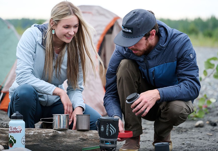 Man and woman making coffee in best fall jackets