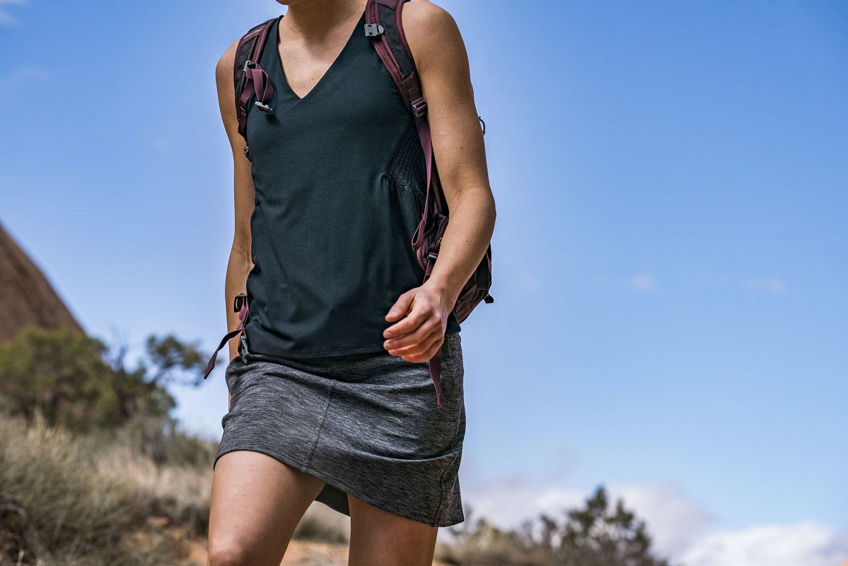 a woman hiking in a skirt