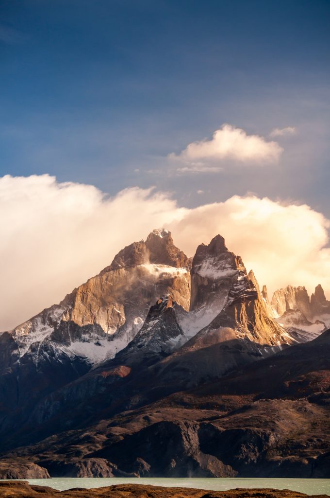 Chile New Patagonia Park Trail 2 Blue lake on a snowy mountains background and cloudy sky Torres del paine