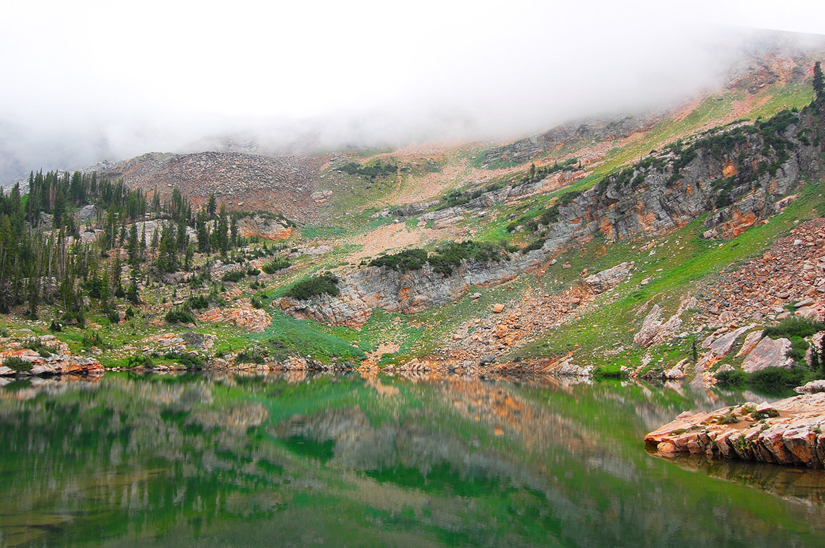 Crecet Lake Alta fog on top of mountain with green lake in front