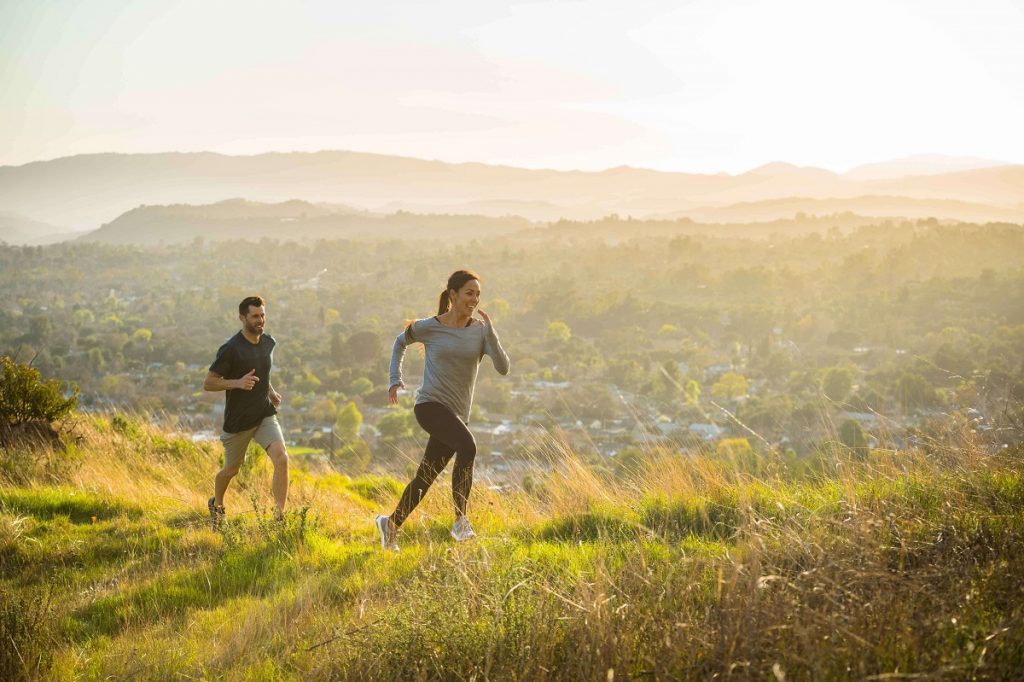 two people running on hill