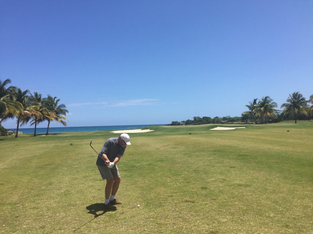 KUHL Sponsored Golf Course Hole - A man dressed in KUHL Golf Shorts taking a swing