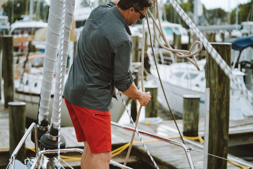 man holding ropes on a boat