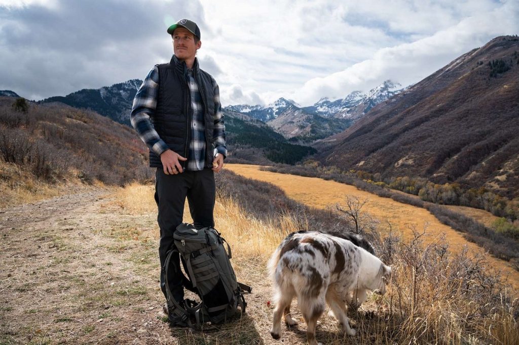 man with two dogs on the road