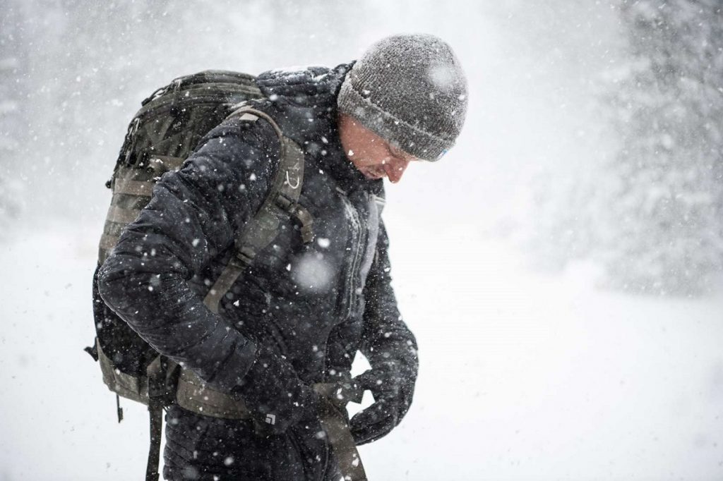 man in black jacket outdoors in snow