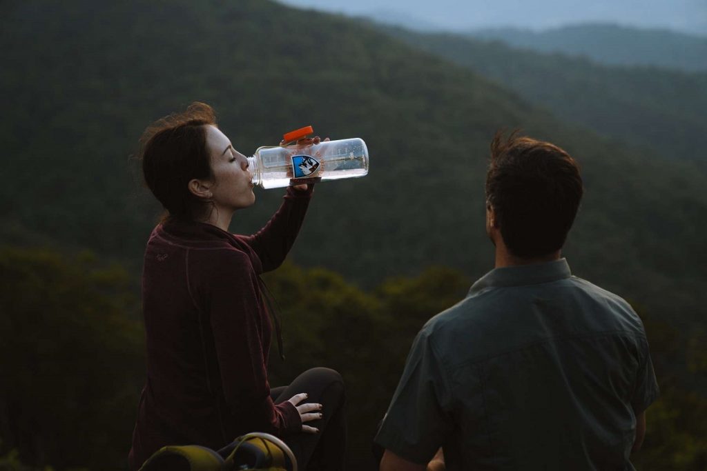 girl drinking water outdoors