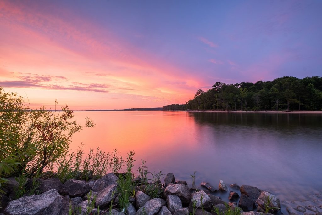 body of water during purple and blue sunset