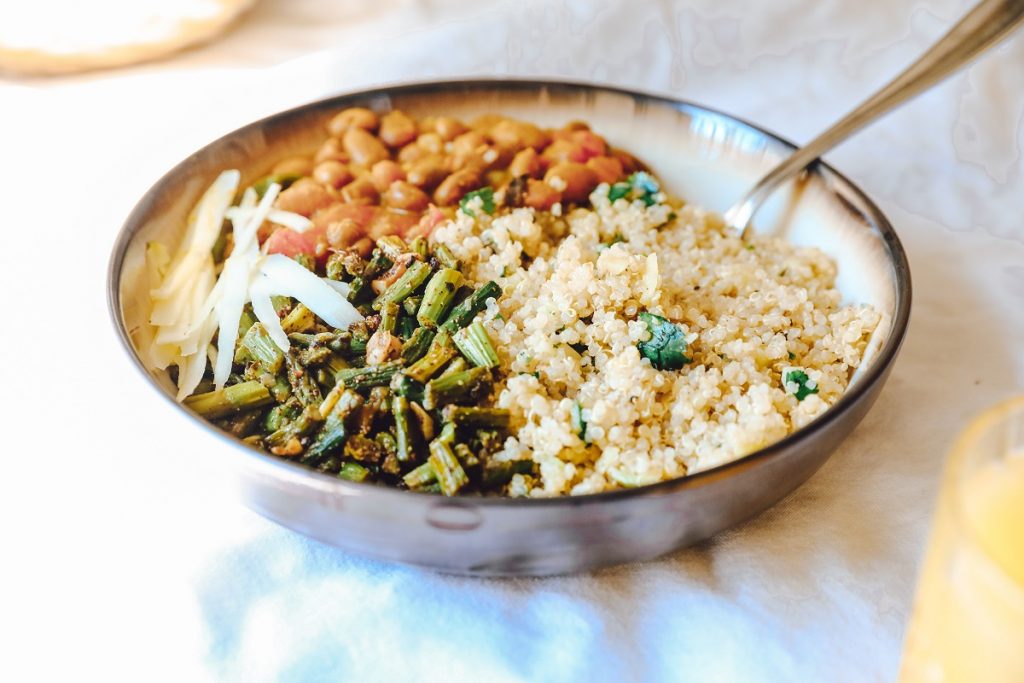 cooked quinoa with pinto beans and asparagus in a bowl