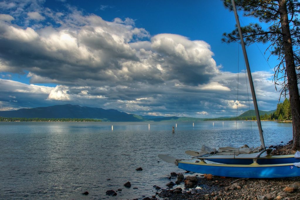 two blue boats near the body of water