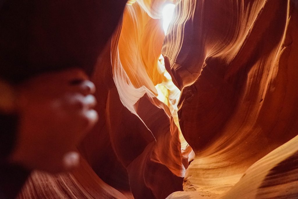 person standing between orange rock formations