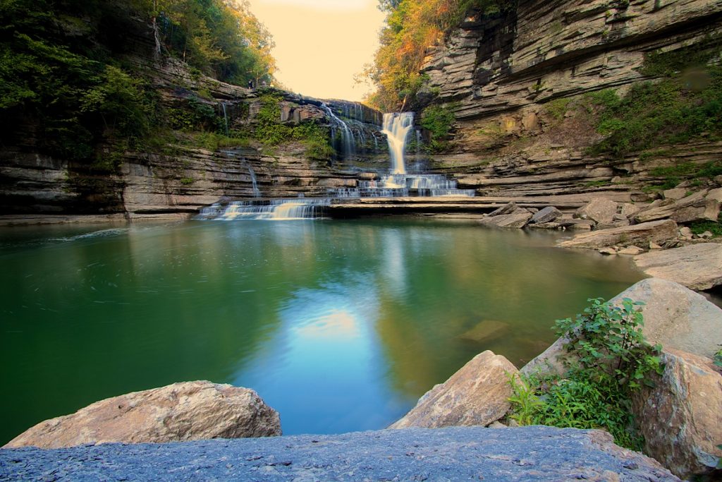 body of water in front of waterfall