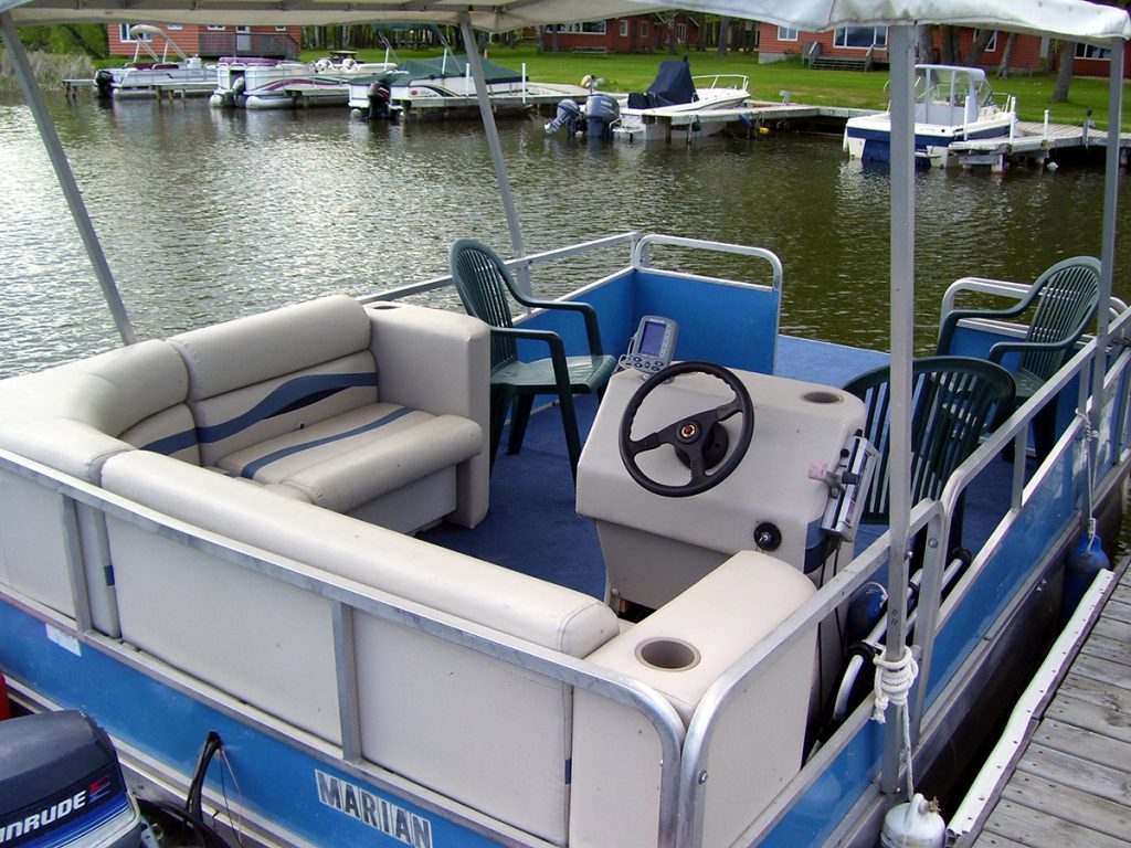 pontoon boat with chairs and fishing accessories