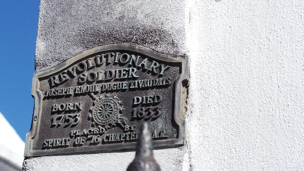 silver grave with letters on a white wall