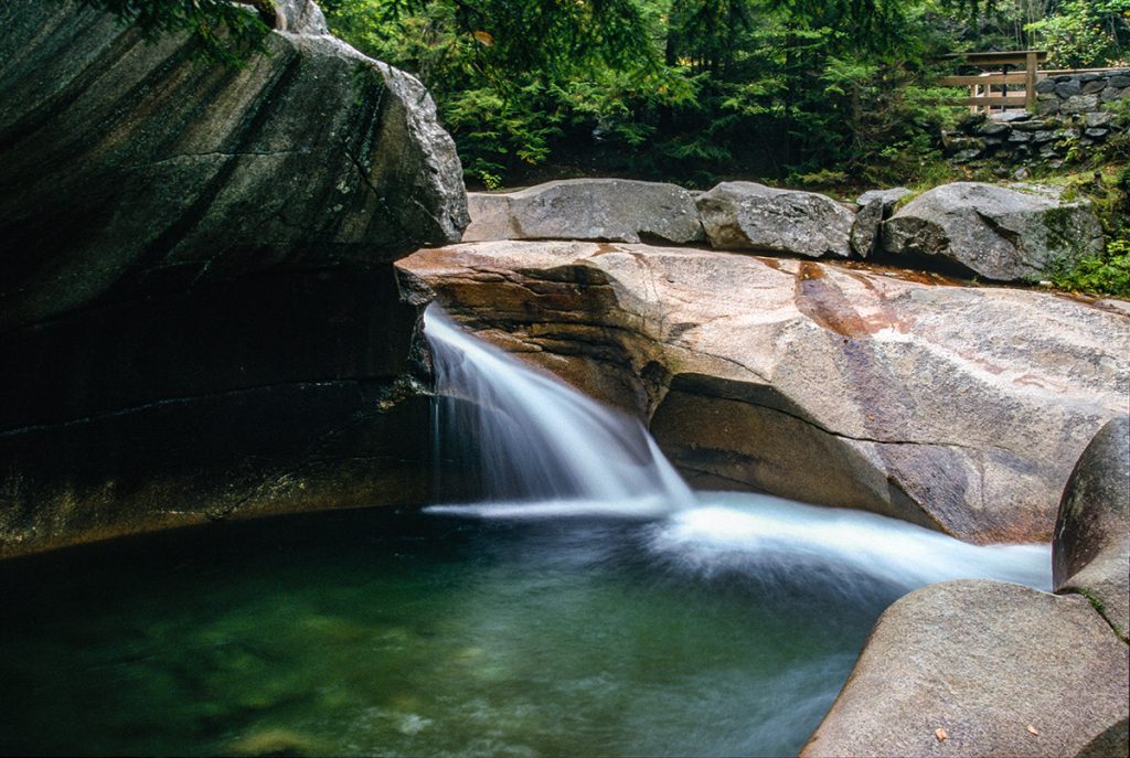 waterfall near brown rocks