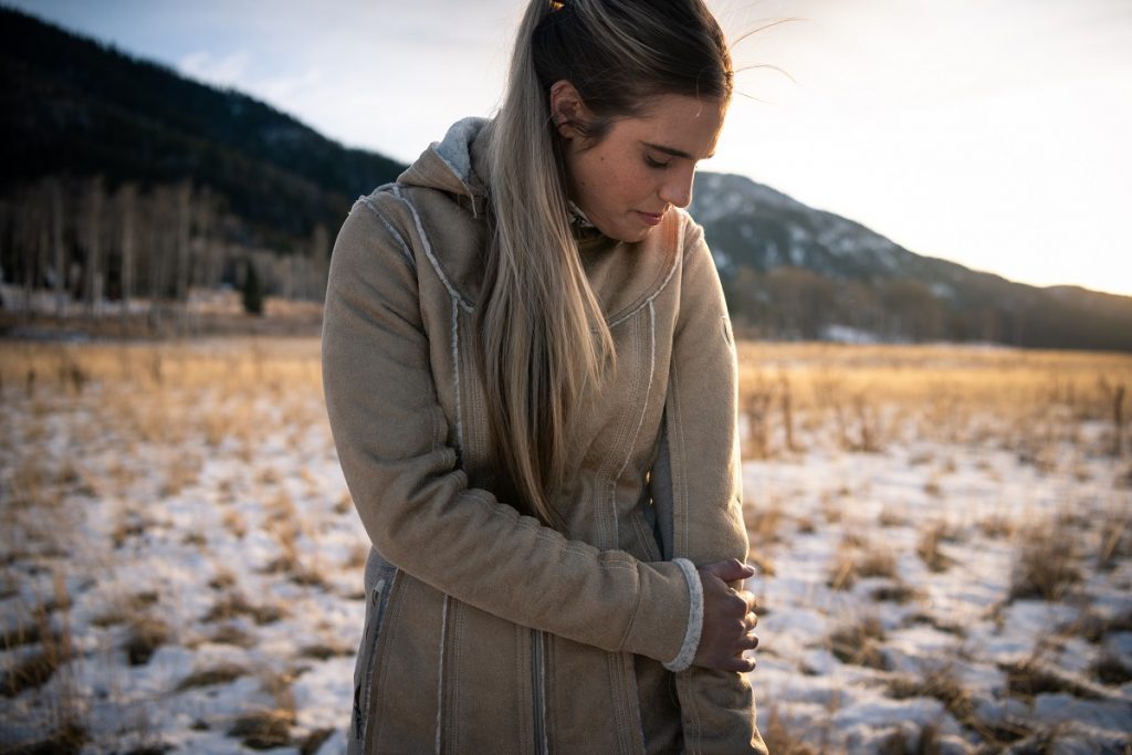 woman in KÜHL Dani Sherpa Trench on a snowy field