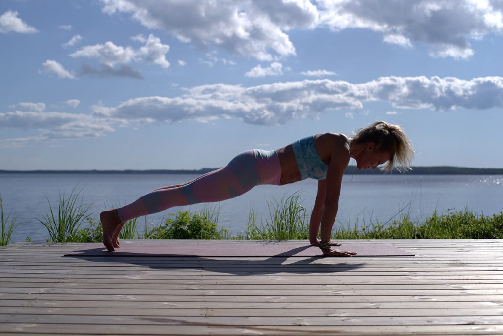 woman doing pushups outdoors during daytime