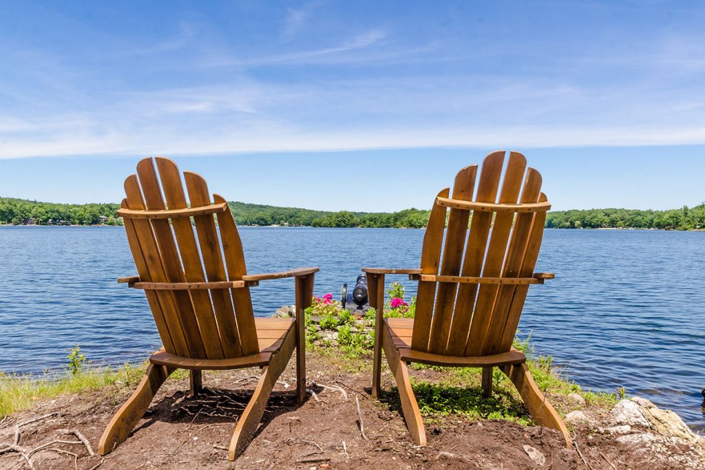 Two Yellow Adirondack Chairs on a Beatch